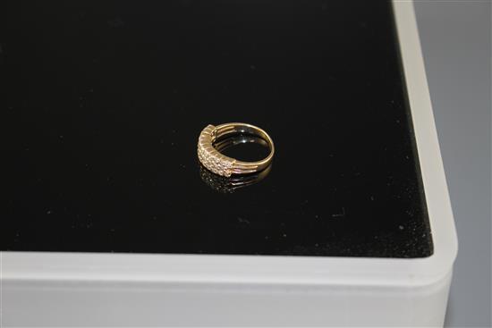 A modern 14k yellow metal and three row diamond set half hoop ring, size O, gross weight 4.3 grams.